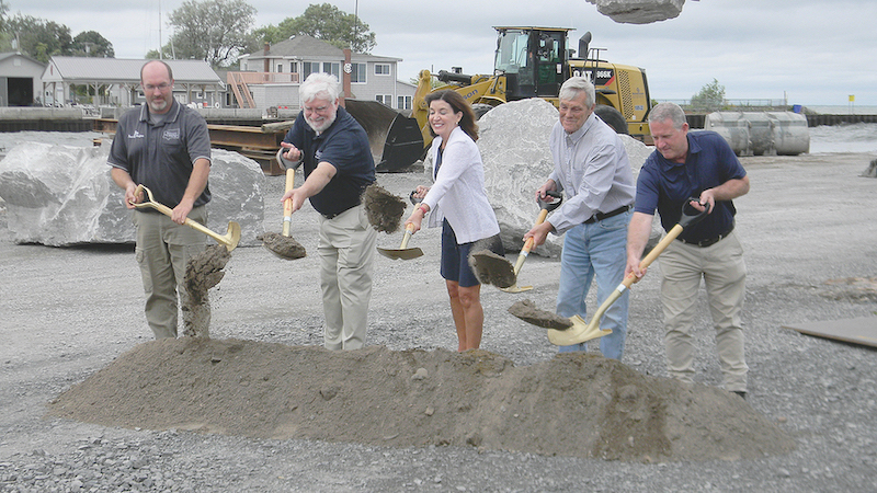 State and local officials joined Lt. Gov. Kathy Hochul at the ceremonial groundbreaking Tuesday for the $14 million Olcott harbor breakwall project. (Photo by Terry Duffy)