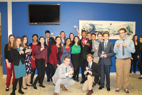 Lewiston-Porter High School students who competed in the DECA Regionals at Grand Island High School gather for a group photo after the award ceremony. Some of the students show the trophies they won at the competition, which tested students on business and marketing knowledge and communication skills. Winners will advance to statewide competition in Rochester in March.