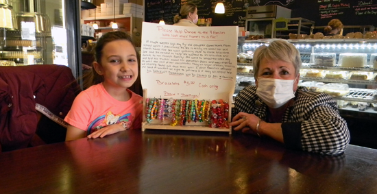 Lewiston-Porter second-grader Serenity Pietrangeli with 1st District Niagara County Legislator Irene Myers and her bracelet display at Lewiston's Village Bake Shoppe. A fundraiser is now underway by Serenity to assist recent Youngstown fire victims. (Photo by Terry Duffy)
