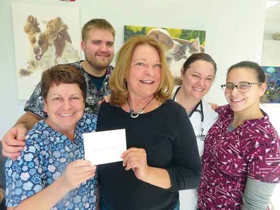Kathryn Serianni, treasurer of Sacarissa Bell Rose Lodge No. 307, presents a donation check to Community Cats Alive. From left, Kelley Casale, Tyler Mayers, Serianni, Dr. Kristen Ruest of the Village Vet and Kristianne Casale.