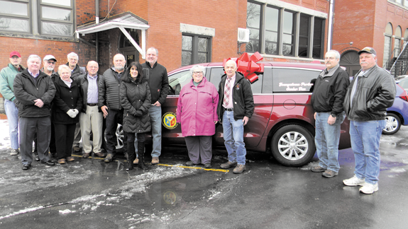 In the photo, village, town and St. John's Episcopal Church officials are shown at the van dedication.