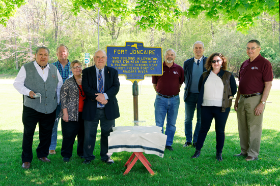 Partners in Le Magazin Royal 300 project, from left: Neil Patterson, Tuscarora Nation; Aaron Dey, Niagara Falls National Heritage Area; Catherine Emerson, Niagara County historian; Robert Emerson, Old Fort Niagara; Tom Collister, Historical Association of Lewiston; Pascal Soares, consulate of France; Sonia Clark, Artpark; and Ken Slaugenhoupt, Historical Association of Lewiston. (Photo by Wayne Peters)