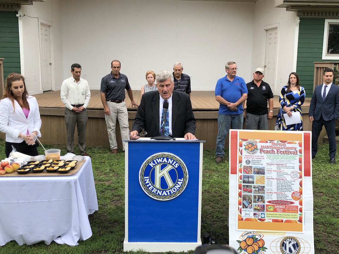 Peach Festival Advisory Chairman Jerry Wolfgang discusses the upcoming Niagara County Peach Festival at a Wednesday media gathering in Academy Park. (Photo by Joshua Maloni)