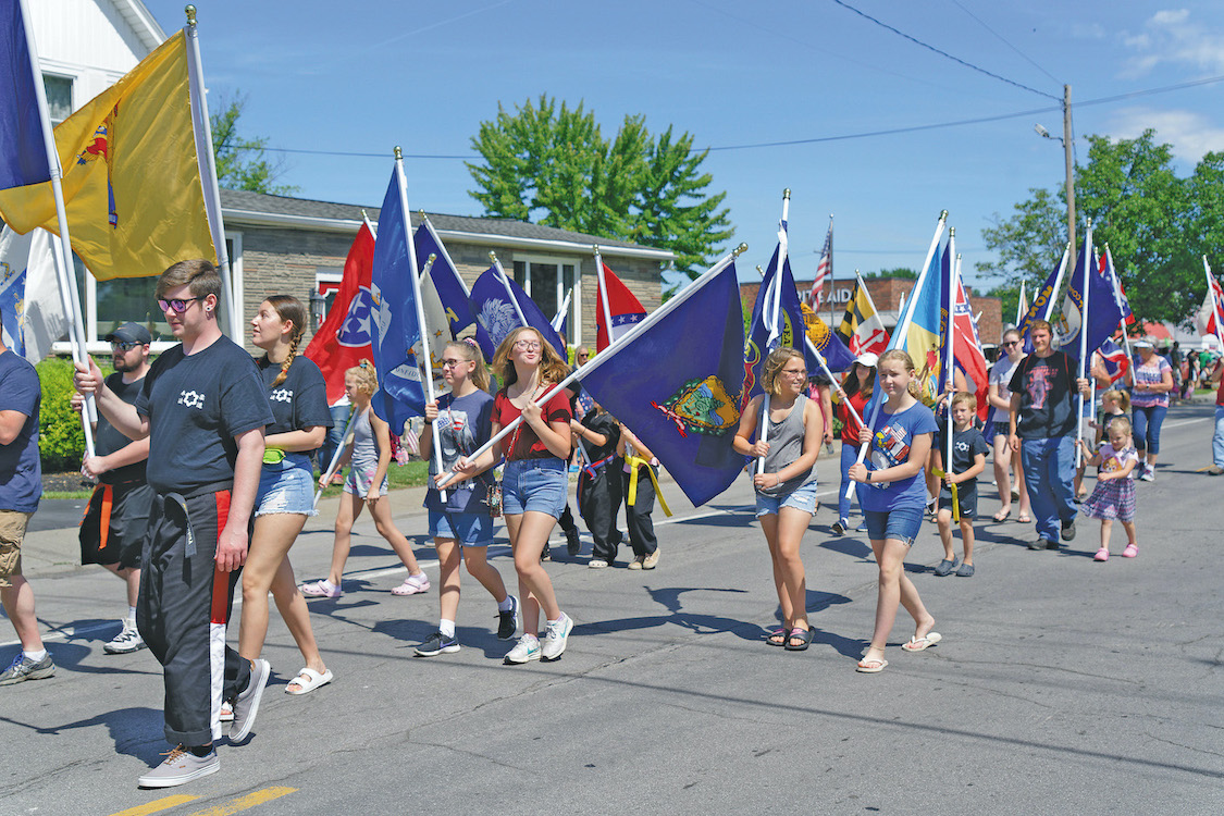 Shown are Marchers with a parade of flags at the 2021 Ransomville Community Faire. (Photo by Wayne Peters)