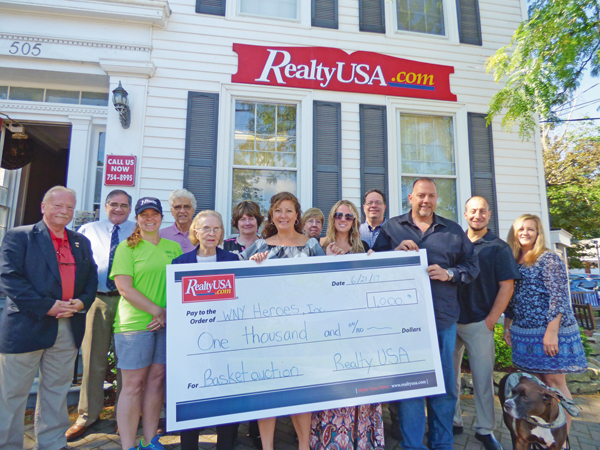 Members of RealtyUSA pose with Chris Kreiger outside of their Center Street office.