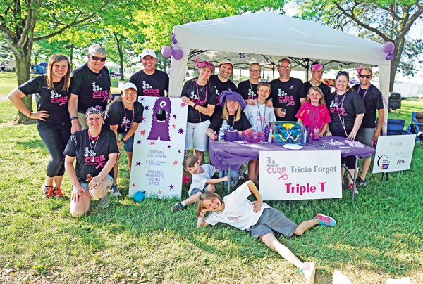 Tricia Forget, the 2016 Relay For Life honorary survivor, poses for a photo with members of Triple Team T. (Photo by Kevin and Dawn Cobello, K&D Action Photo and Aerial Imaging)