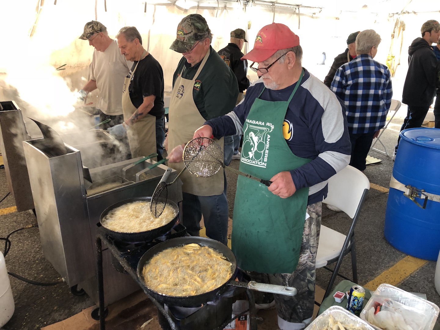 Members of the Niagara River Anglers fry up smelt at Friday's festival in Lewiston.