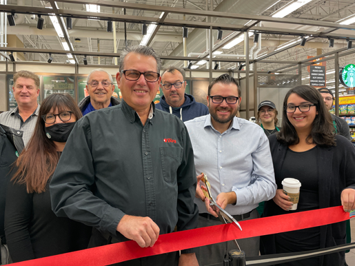 Anthony DiMino; his son, John; Starbucks representatives; and friends from the Niagara River Region Chamber of Commerce celebrated a ribbon-cutting ceremony on Monday.