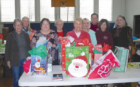 Janet Brooks, chairman of children's gifts, front row third from left, with some of her wrappers. (Submitted photo)