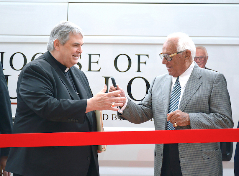 Restaurateur and philanthropist Russell Salvatore hands over the keys to a Ram ProMaster 2500 van to Bishop Michael W. Fisher. The van will be used to make deliveries to the 161 parishes and 13 schools of the Diocese of Buffalo. (Photo by Nikki Dzimira, Diocese of Buffalo)