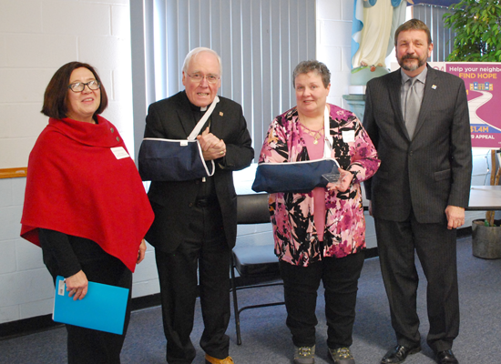 From left: Kathleen Hall, Catholic Charities of Buffalo Niagara County district director; the Most Rev. Richard J. Malone, bishop of the Diocese of Buffalo; `Hero of Hope` awardee Lynn Siegfried, president of Community Care at St. John de LaSalle Parish in Niagara Falls; and Dennis C. Walczyk, president and CEO of Catholic Charities of Buffalo.