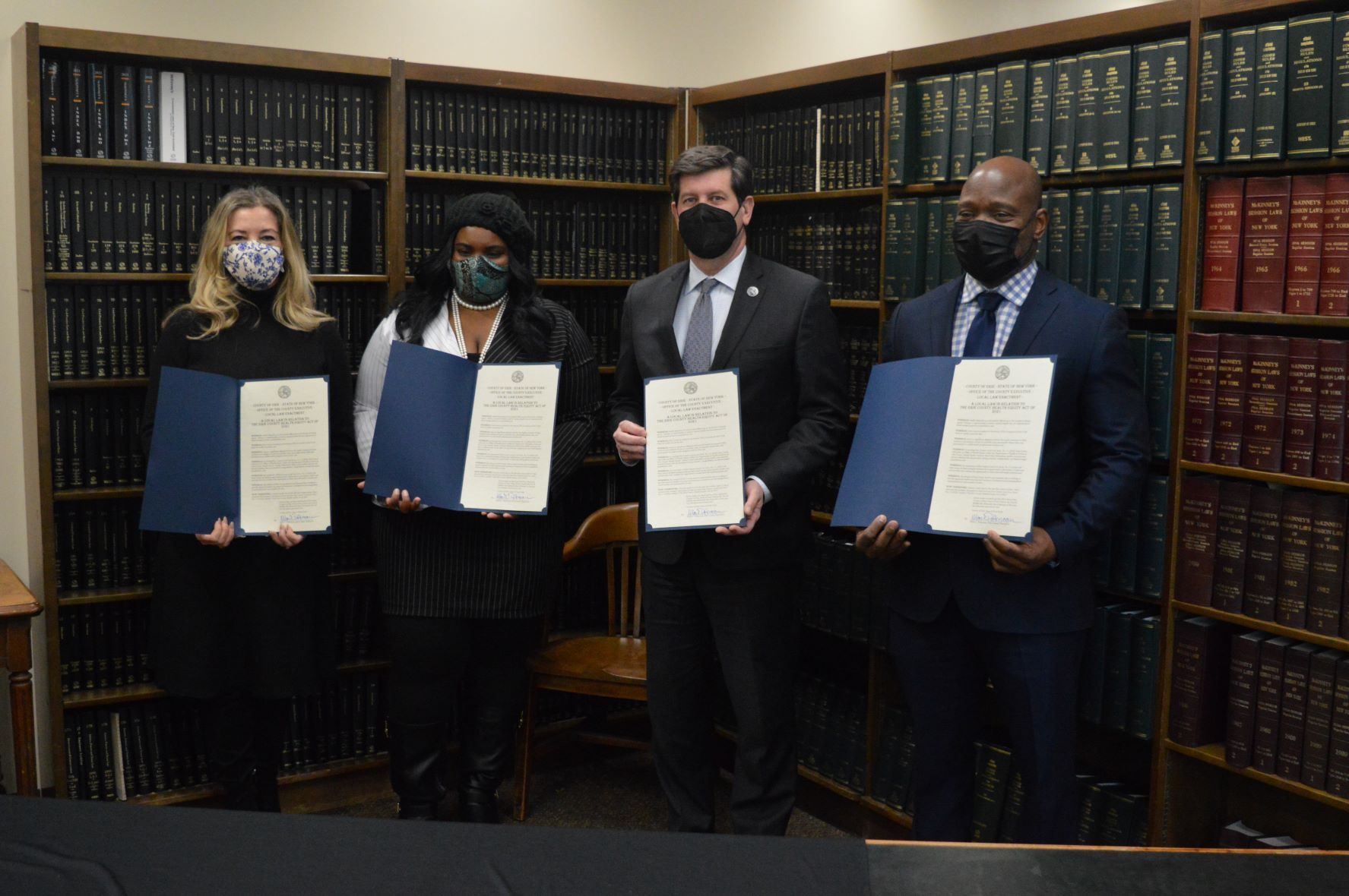 From left: Erie County Legislator Lisa Chimera, Legislature Chairwoman April N.M. Baskin, Erie County Executive Mark Poloncarz, and Legislator Howard Johnson hold copies of the newly signed Local Law Intro. No. 3-1 (2021) establishing an office of health equity within the Erie County Department of Health. (Submitted photo)