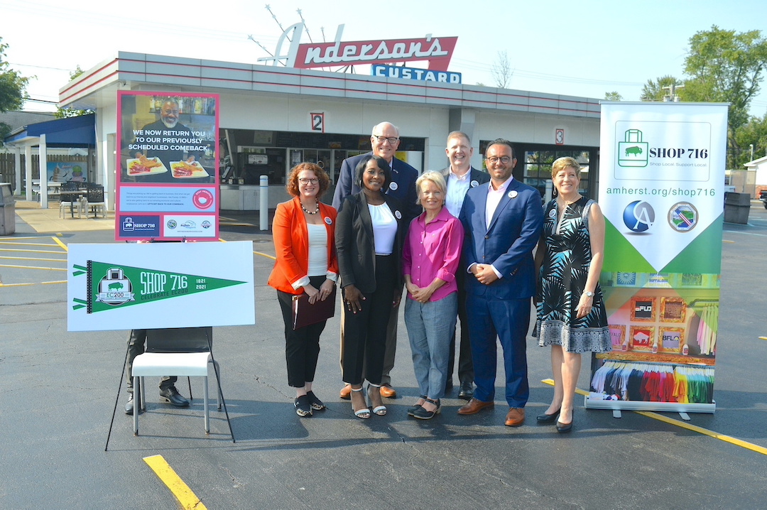 Deputy Erie County Executive Maria Whyte, Park Vue Soul Food Bar and Restaurant's Harrita West, Town of Tonawanda Supervisor Joseph Emminger (back row), Holly Anderson of Anderson's Frozen Custard, Visit Buffalo Niagara's Patrick Kaler (back row), Amherst Chamber of Commerce's A.J. Baynes, and Ken-Ton Chamber of Commerce's Catherine Piciulo join for a photo after the launch of `Shop 716` at Anderson's Frozen Custard on Sheridan Drive. The campaign has generated more than $1.2 million in revenue for local small businesses and has returned for the fall and holiday shopping seasons.