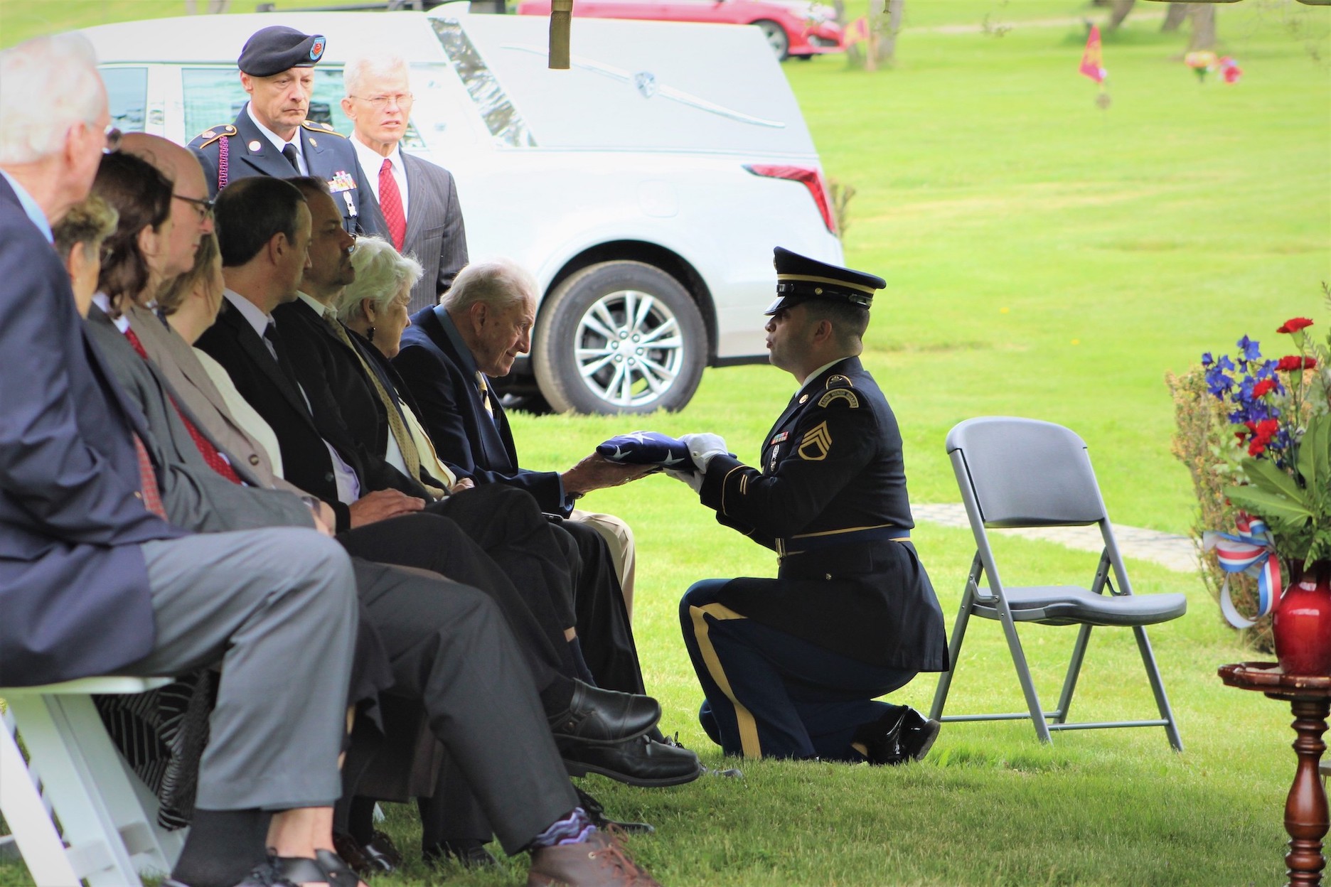 Staff Sgt. Natanael Perez presents the American flag to Gloyd `Dean` Kimball, cousin of late Korean War MIA Cpl. Robert Charles Agard Jr., as remains were interred on Friday, May 27. (Photo courtesy of readMedia)