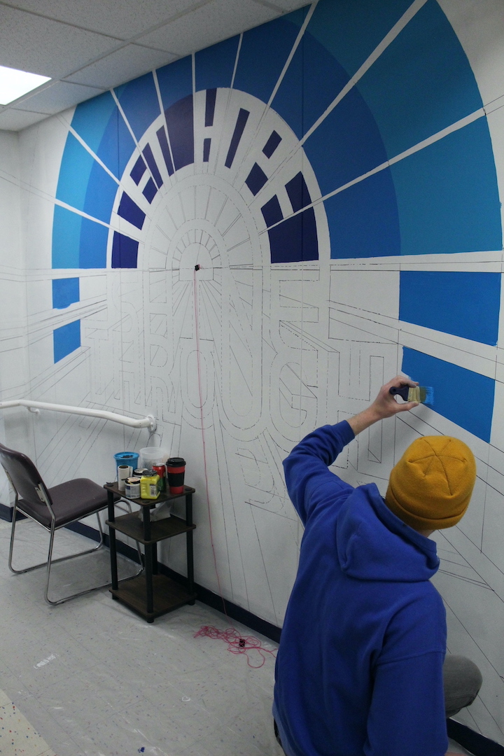 Casey Milbrand at work on a mural for Family Promise of Western New York. (Submitted photo)