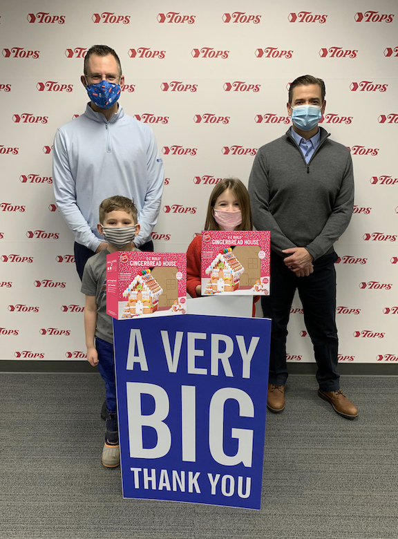 Pictured, back row: The Children's Hospital of Buffalo Foundation Vice President Andrew Bennett and Tops President and COO John Persons; and front row: Bennett's children, Robert and Adelaide. (Image courtesy of Tops)