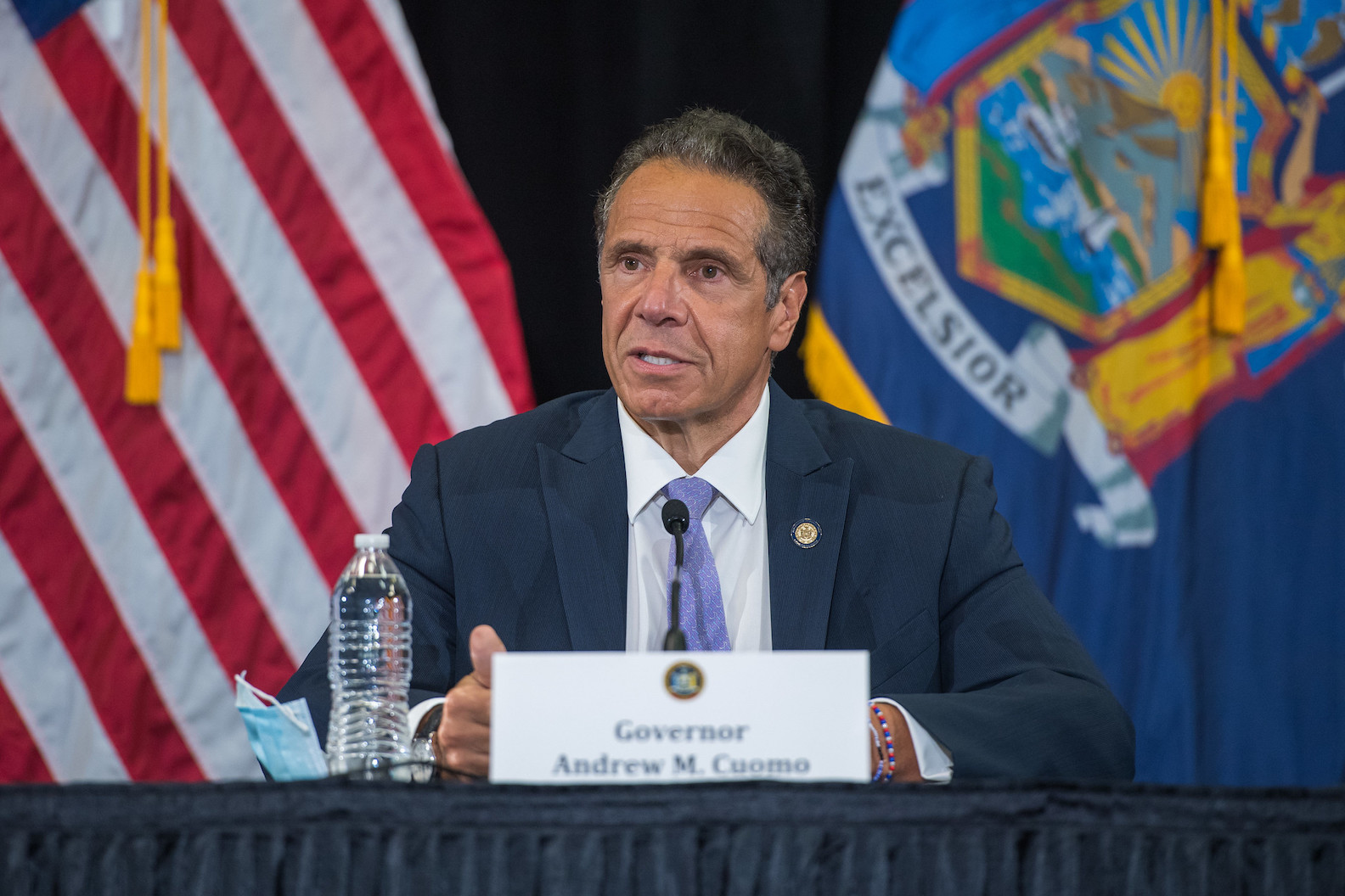Gov. Andrew Cuomo held a press briefing Monday morning on Long Island. (Photo and blue graphics courtesy of the Office of Gov. Andrew M. Cuomo)