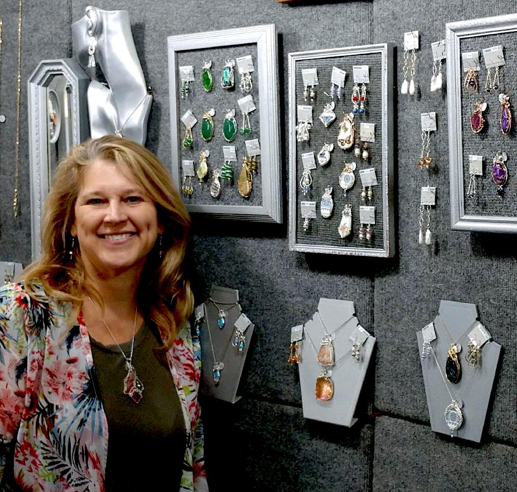 Patty and Michael Cancilla are seen on June 4 in their respective artists' booths at the American Craftsman Artisan Show at the Kenan Center Arena in Lockport.