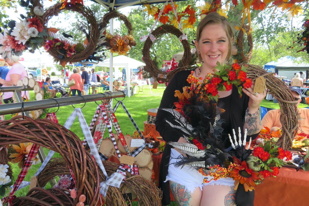 Courtney Stacey-Mock shows one of the wreaths she designed.