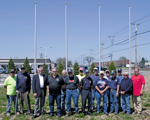 Supporters of the DeGlopper Memorial expansion were on hand as flagpoles were erected this week.