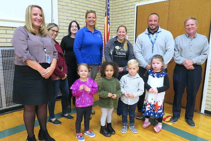 The Grand Island Board of Education with Sidway Principal Michael Antonelli, back row, second from left; and four pre-kindergarten students who served as leaders for the pledge of allegiance.