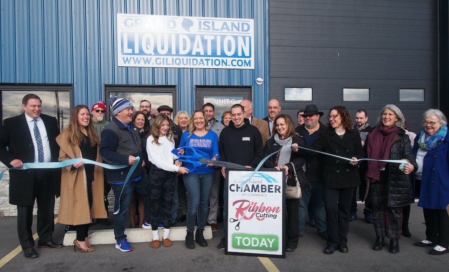 Nicole Cannarozzo and her family and friends, along with elected officials and members of the Grand Island Chamber of Commerce, celebrate the ribbon cutting.