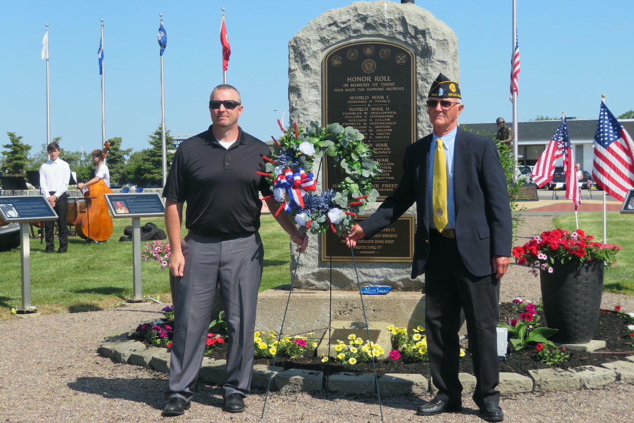Brian Tippet, commander of the VFW, and Ray DeGlopper, commander of the American Legion, present a wreath at the memorial.