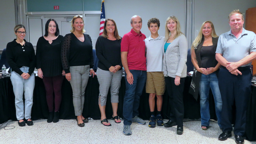 Grayson Shelp is pictured with his parents, Edwin Shelp Jr. and Kimberly Shelp, and the Grand Island Board of Education.