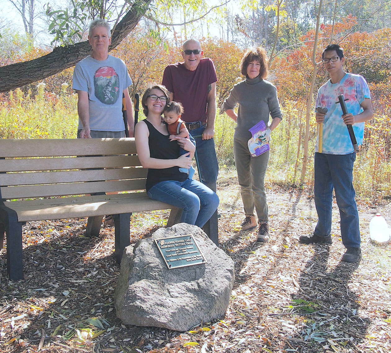 Standing from left: Tim Carr, Tom Burke, Karen Carr Keefe and Nathan Keefe. Seated on the bench: Chelsea Carr and her infant son.