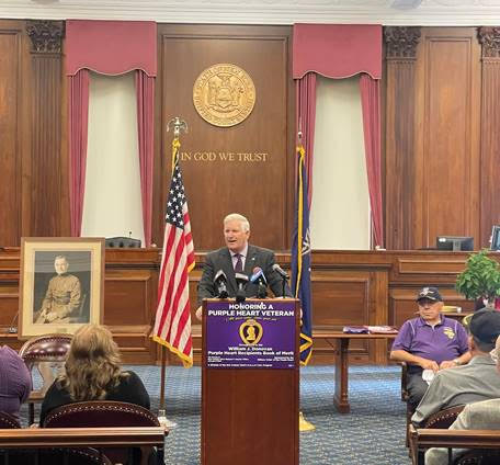 Erie County Clerk Michael P. Kearns pays tribute to Purple Heart recipients who were added to the William J. Donovan Purple Heart Book of Merit for 2023. The program included a dedication and flag-raising ceremony that included honorees, family members, area veterans, and the Military Order of the Purple Heart, chapters 187 and 264. (Submitted photo)