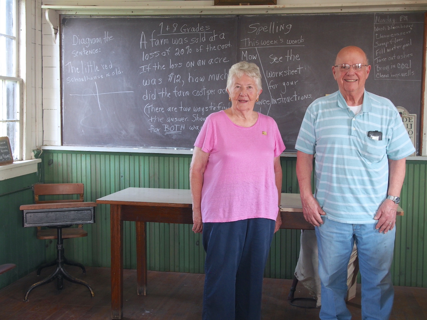 June Crawford, chair of the Historic Preservation Advisory Board, and Joseph Macaluso, past chair, enjoy showing off the one-room schoolhouse at Kelly's Country Store.