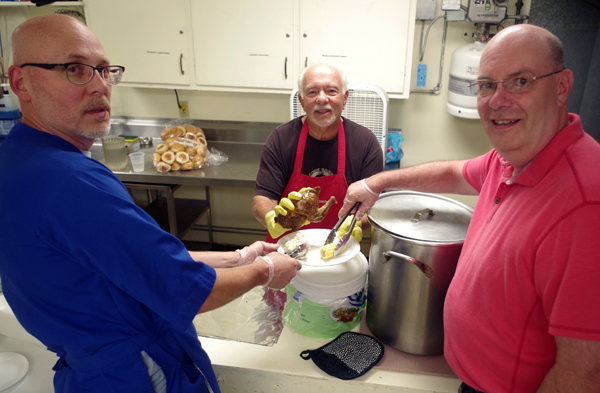 The Knights of Columbus Mary Star of the Sea Council donated $250 to the Grand Island Lions Club in support of the Lions Special Kids Picnic, which took place Wednesday. Pictured in the kitchen making dinner plates are, from left: Dave Forster, Dominic DeFeo and Tom Vogel. Not pictured is chicken dinner chairman Bill Gworek Sr. (Photos by Larry Austin)
