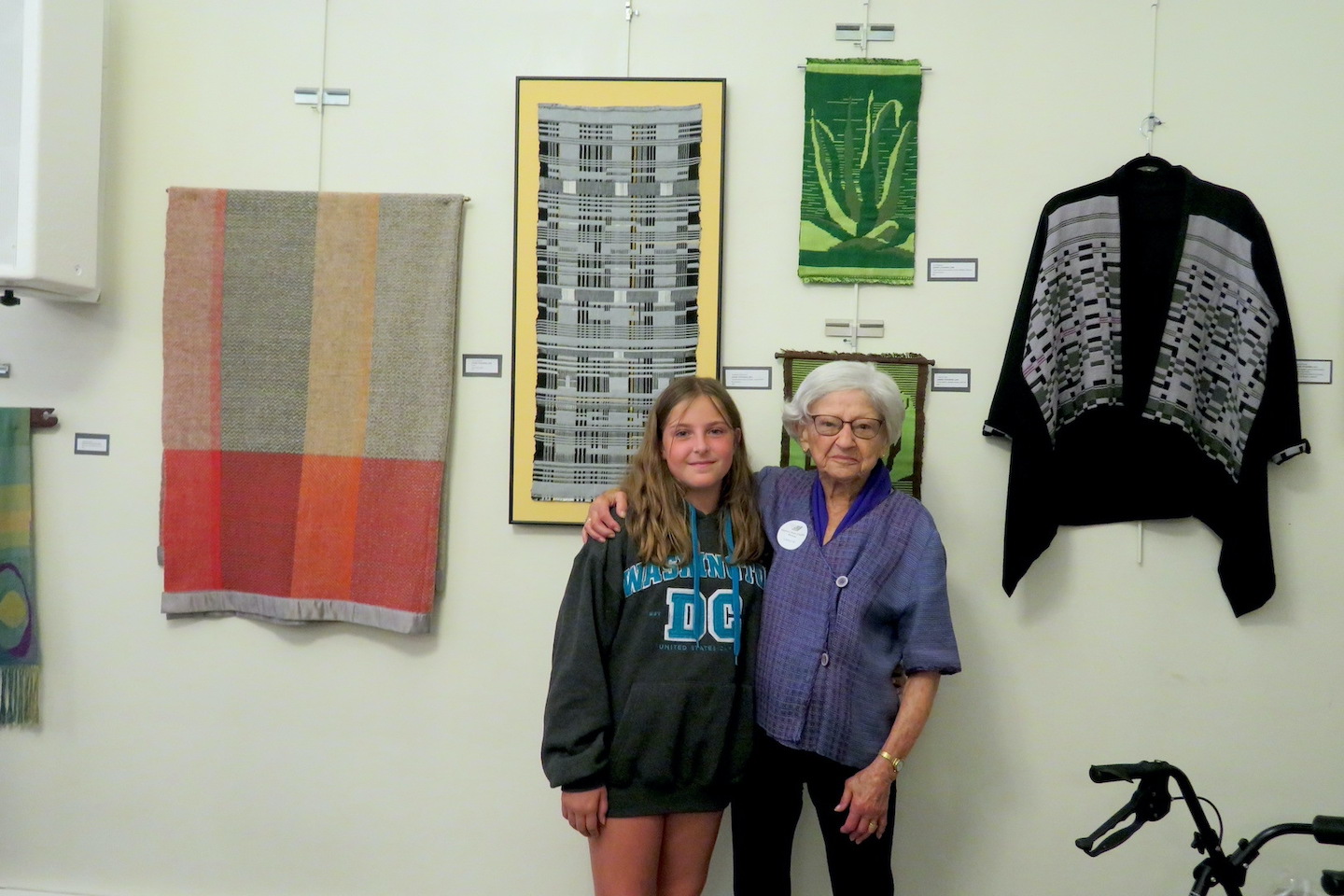 Some of Lenore Tetkowski's weavings are on display through the end of this month at Unity Church of Buffalo, 1243 Delaware Ave. Tetkowski and a young friend are shown at the July 9 opening of her exhibit at the Unity Church of Buffalo.