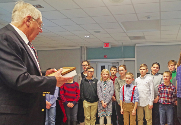 Veteran Richard Pealer talks to Grand Island Central School District student prior to presenting them with a flag that flew over the Capital. (Photo by Larry Austin)