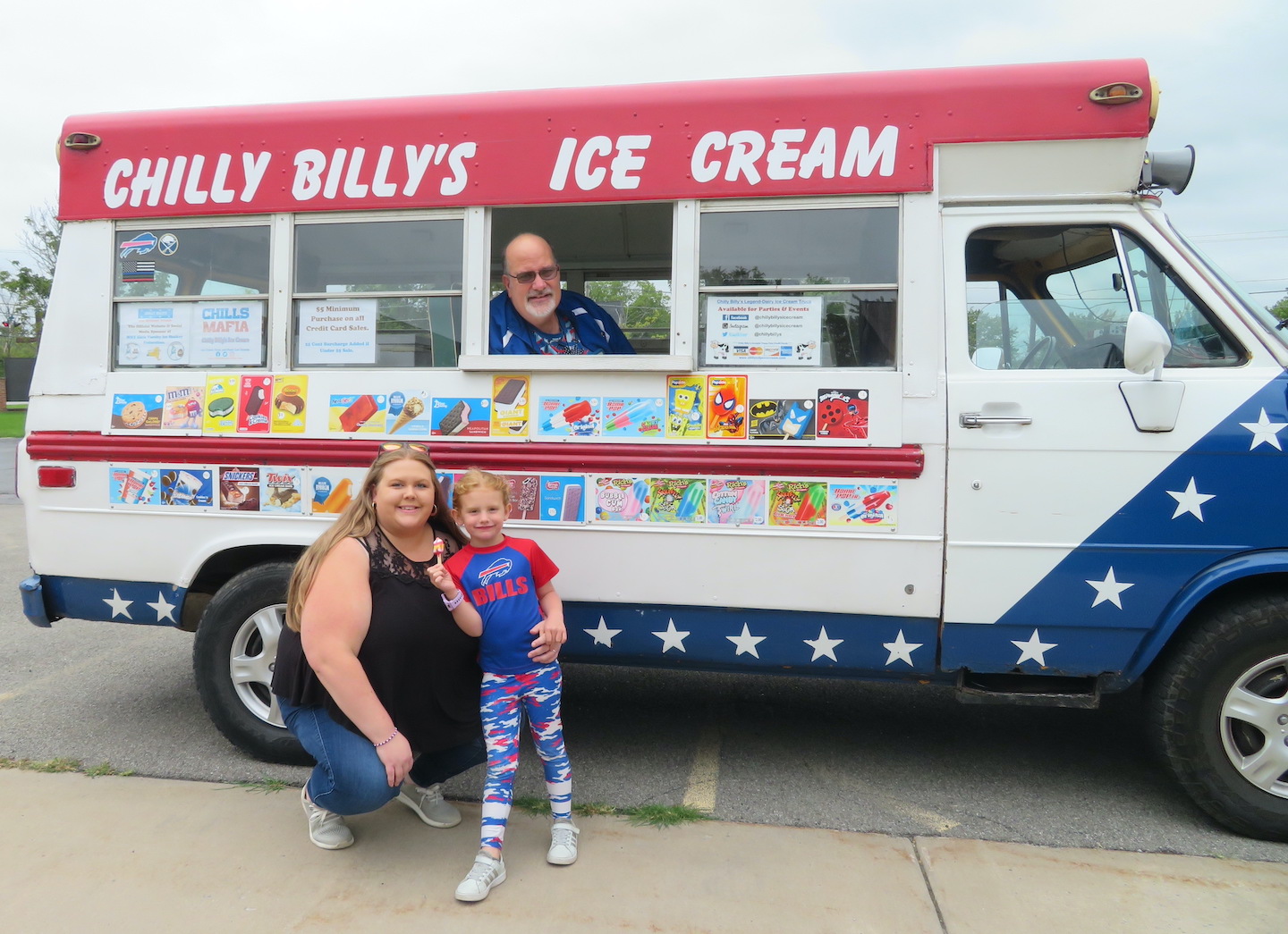 Assistant Director Tracy Marrs and a student in the pre-kindergarten program enjoy ice cream at Chilly Billy's ice cream truck.