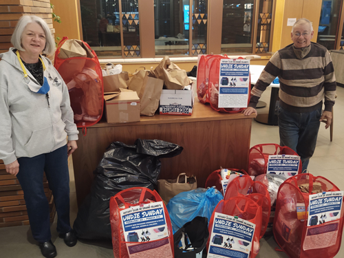 Sherry Miller, president of the Rotary Club of Grand Island, left, and member Michael Heigel, with all the donations to sort this week at the Visitor Center on Grand Island.