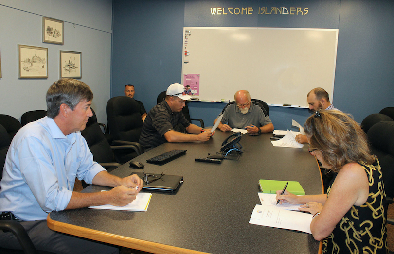 Members of the Town Board meet to redo the motion calling for a draft local law to review zoning for warehouses and other buildings on Grand Island.