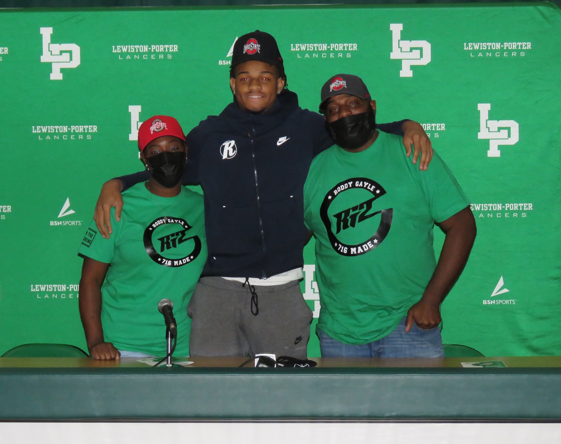 From left, Latoya Gayle, Roddy Gayle Jr. and Roddy Gayle Sr. pose for a photo following his commitment to Ohio State University. (File photo)