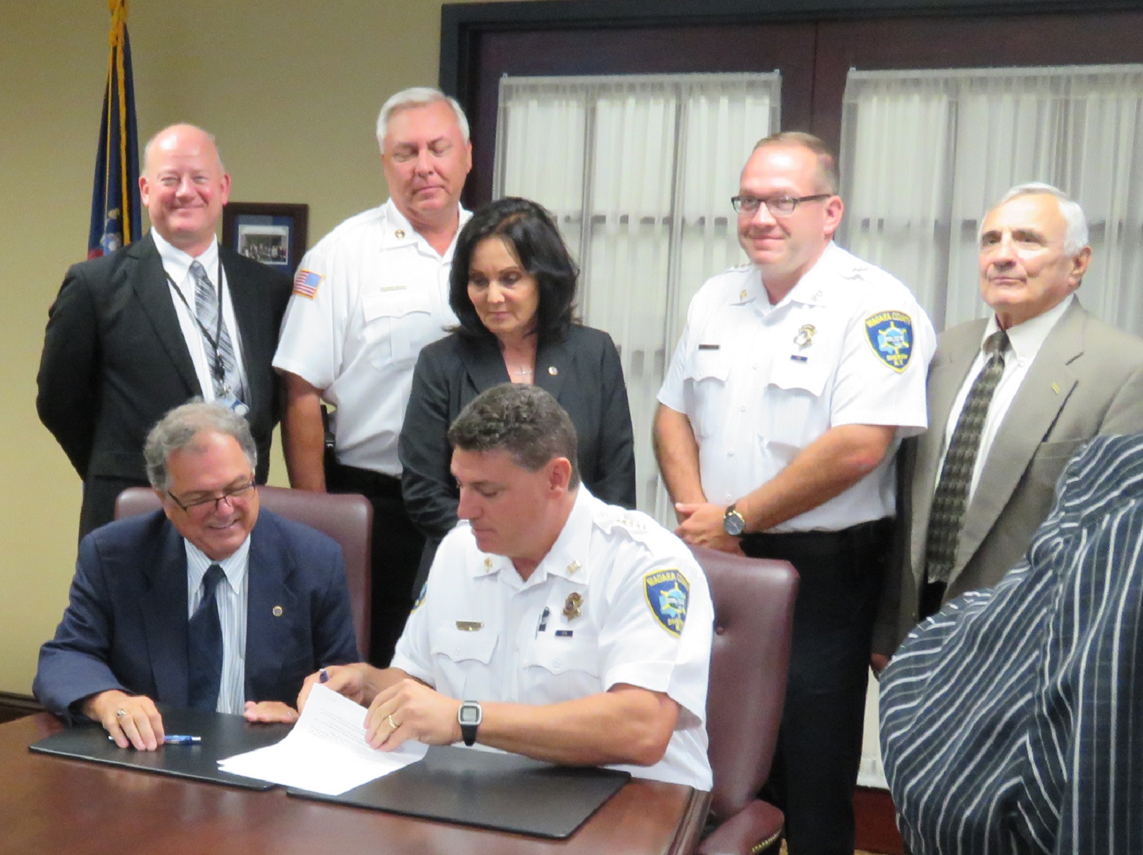 NCCC Interim President William Murabito (left, seated) and Niagara County Sheriff James Voutour (right, seated) sign a memorandum to provide an officer on campus. Also pictured, from left,  Michael Dombrowski, NCCC vice president for operations; Ross Annable, chief of Campus Public Safety; Gina I. Virtuoso, NCCC Board of Trustees vice chairperson; Michael J. Filicetti, undersheriff; and William L. Ross, NCCC Board of Trustees chairperson.