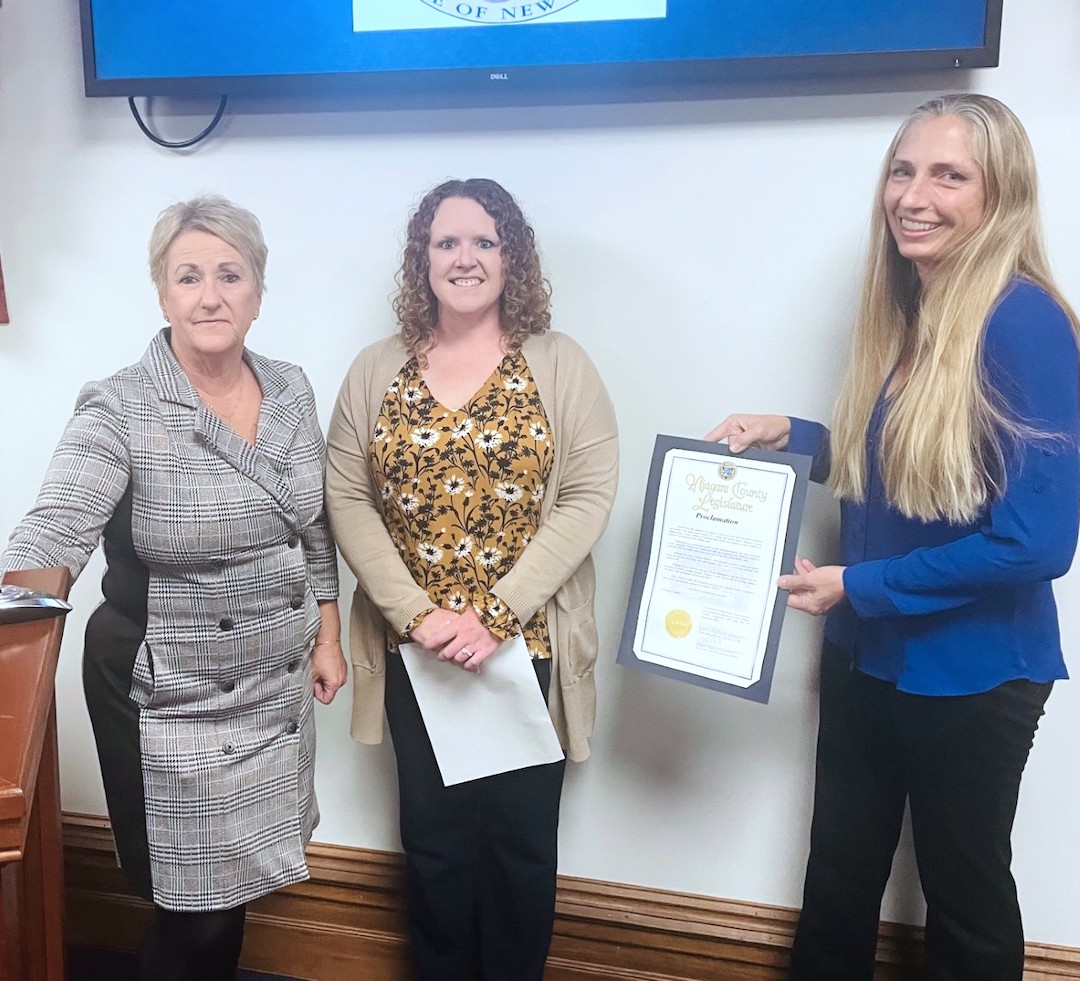 Legislature Irene Myers, left, presents the proclamation for National Adoption Awareness Month to Niagara County Department of Social Services Commissioner Meghan Lutz and Director of Services Billie Tylec, who oversees the county's adoption program. (Submitted photo)