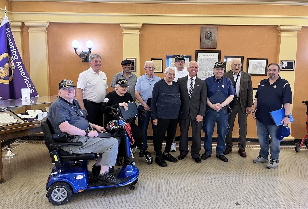County Clerk Joseph A. Jastrzemski welcomes veterans to the Niagara County Courthouse, including a stop for coffee and doughnuts at the VSA, and a tour of the Purple Heart display. 