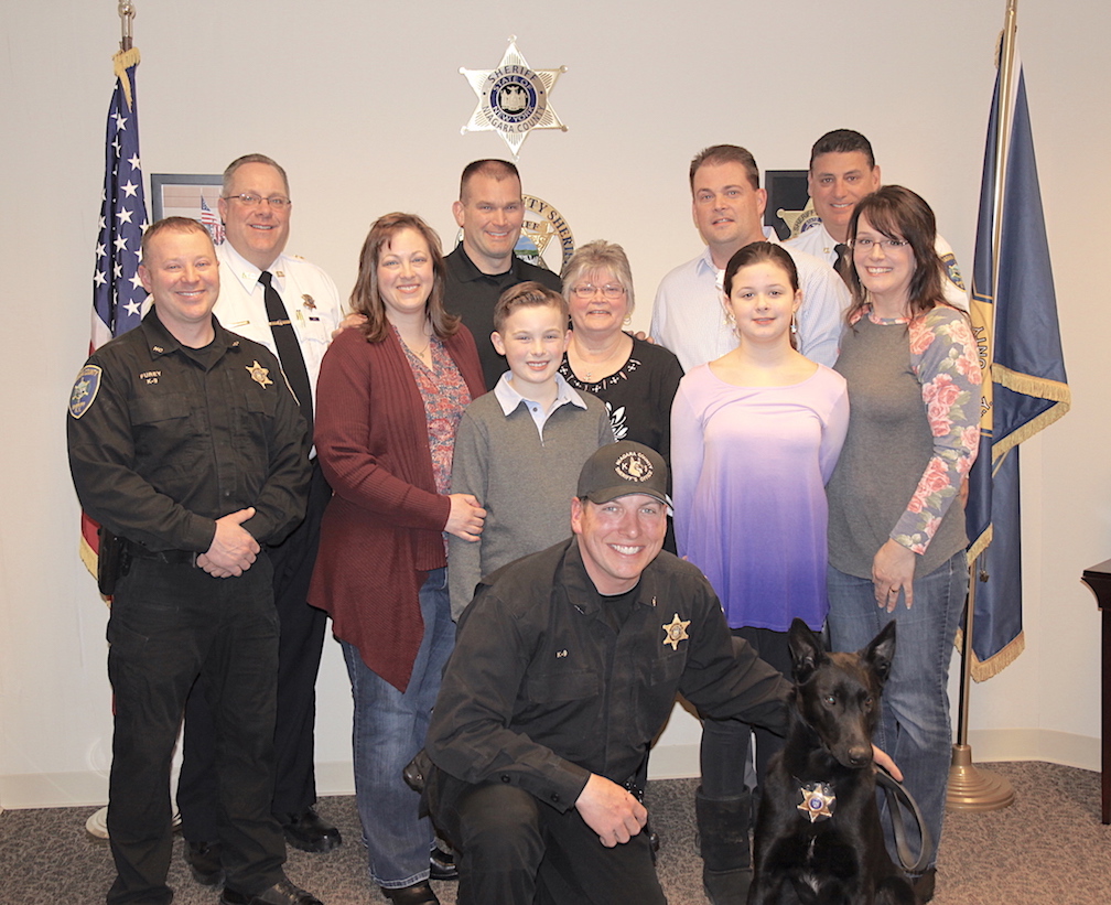 Pictured, kneeling, is Niagara County Sheriff's Office Deputy Rich Bull along with K-9 Chief. In the first row: K-9 Deputy Sean Furey, Allison Harmon, Max Harmon, Pam Harmon, Samantha Harmon and Jennifer Harmon. In the second row: Chief Deputy Patrick Weidel, Corey Harmon, Todd Harmon and Sheriff James Voutour.