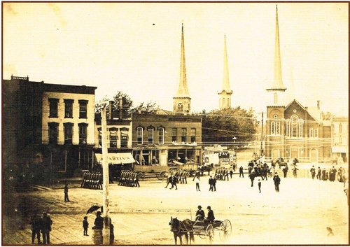 A photo from 1888-90 depicting a parade on the `Big Bridge,` where the Lockport Municipal Building now stands. From left: First Free Congressional Church, First Presbyterian Church, Methodist Episcopal Church and St. Patrick's Catholic Church. (Courtesy of The History Center of Niagara)