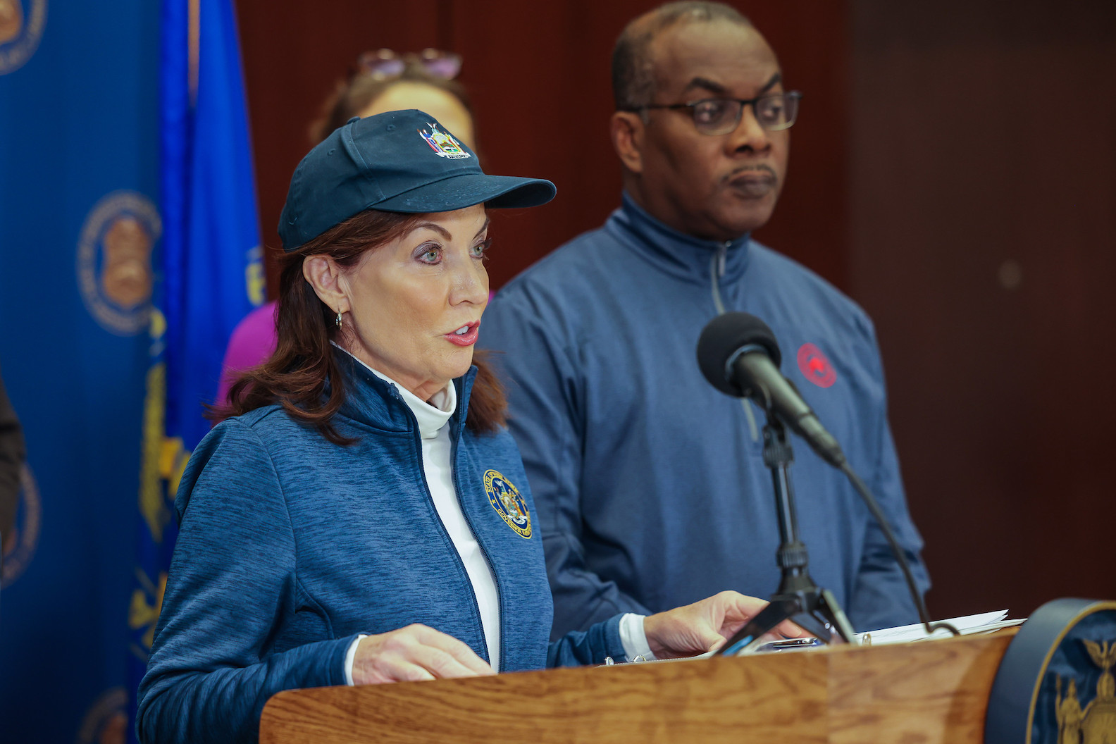 Gov. Kathy Hochul holds a press briefing at Buffalo Police headquarters with Mayor Byron Brown (looking on) and Erie County Executive Mark Poloncarz (Photo by Mike Groll/Office of Gov. Kathy Hochul)