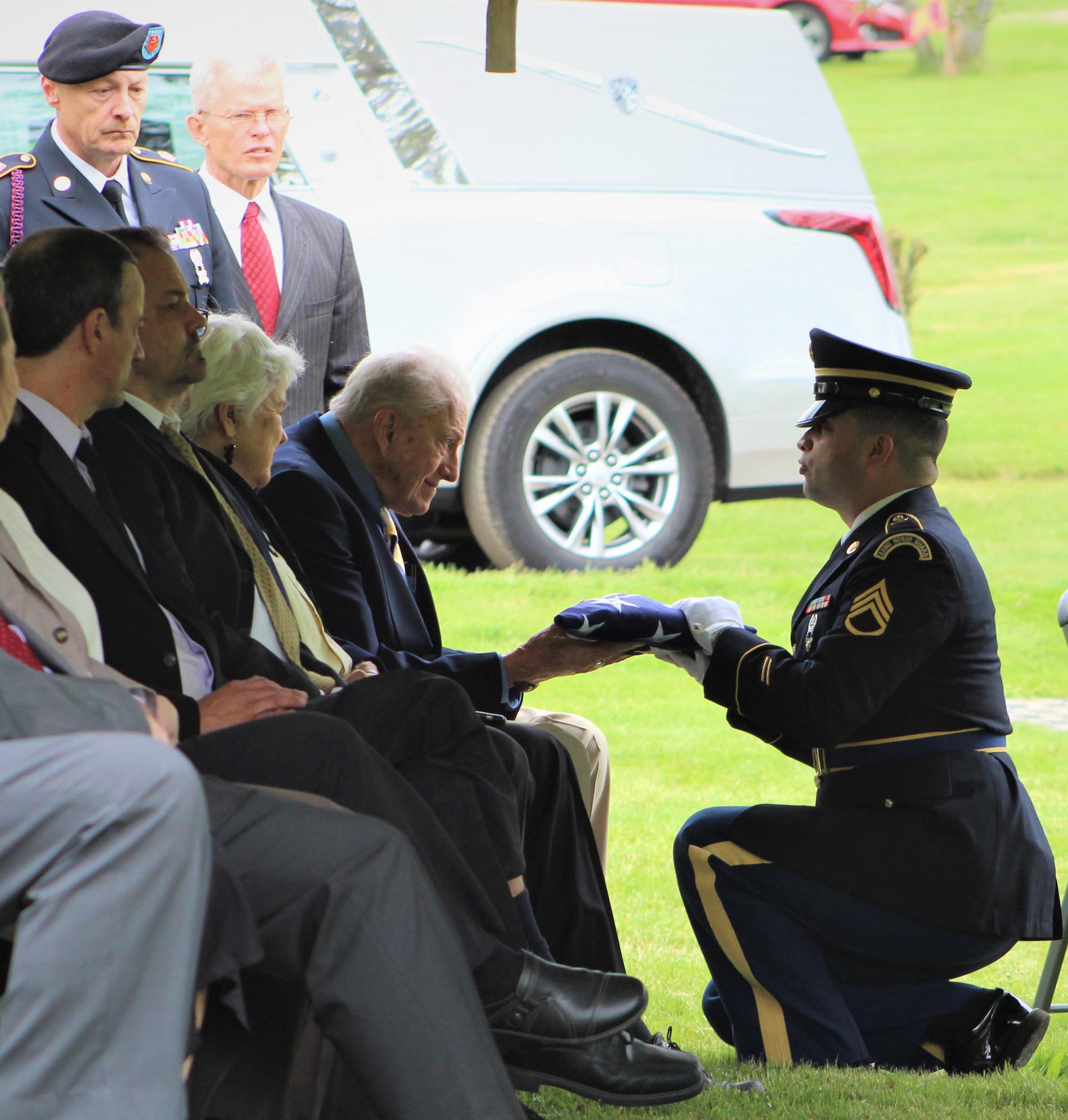 New York Army National Guard Staff Sgt. Natanael Perez presents the American flag to Gloyd `Dean` Kimball, cousin of Korean War MIA Cpl. Robert Charles Agard Jr., on May 27, 2022, at Forest Lawn Memorial Park Cemetery in Elmira. Agard's remains were returned home after more than 70 years listed as missing in action following his death in North Korea. The New York Army National Guard conducted 7,753 military funeral services in 2022. (U.S. Army National Guard photo by 1st Lt. Lauren Warner)