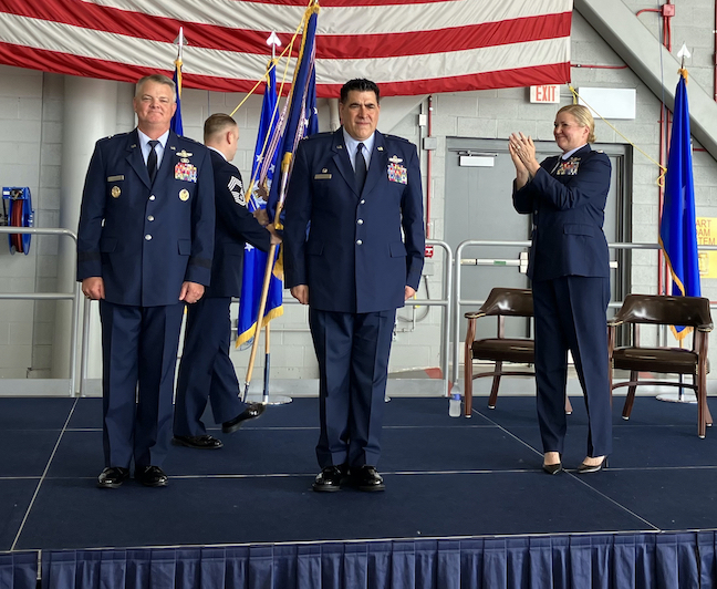 Brig. Gen. D. Scott Durham, left, looks on as Col. Joseph Contino officially assumes command with former commander Col. Lara Morrison applauding.