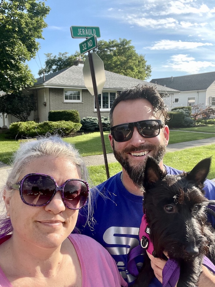 Pictured: Brook, Max, and their dog, Myra, stand at the epicenter of the community sale event on the corner of 32nd and Jerauld avenues.