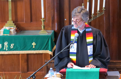 Shown in this interfaith community prayer service file photo is the Rev. Mark Breese, agency minister at Community Missions.