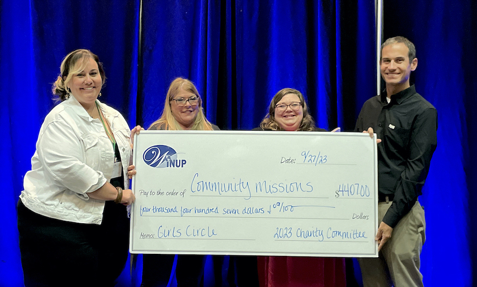 At a check presentation inside the Seneca Niagara Resort & Casino on Wednesday, Women's International Network of Utility Professionals conference charity committee co-chairs Kristin J. Duggins and Judy Hurd present a check for more than $4,400 to Community Missions of Niagara Frontier's Girls Circle Lead Facilitator Elizabeth Freiburger and Vice President of Public Relations and Development Christian Hoffman. (Photo by Joshua Maloni)
