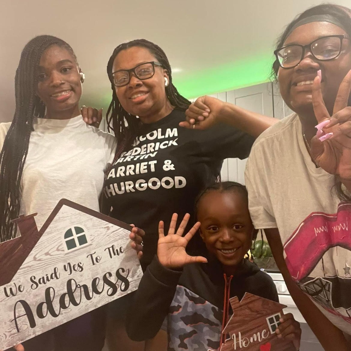 New Habitat homeowner Jessica Billingslea-Young celebrates in her Habitat home with her children: NaJah, NyAsia and Caleb.